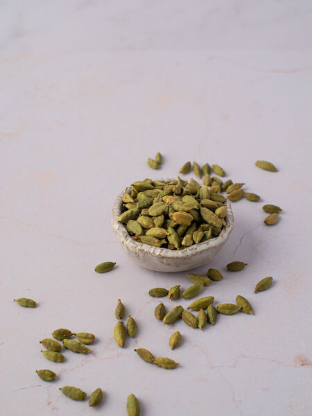 Whole green cardamom are small seed capsules with papery outer shells. They have ridges running along their length and taper at either ends. When fresh, and quality-dried, they are green in color and somewhat plump. The capsules are triangular in cross-section, and when opened reveal 15-20 small black-brown and intensely aromatic seeds. 