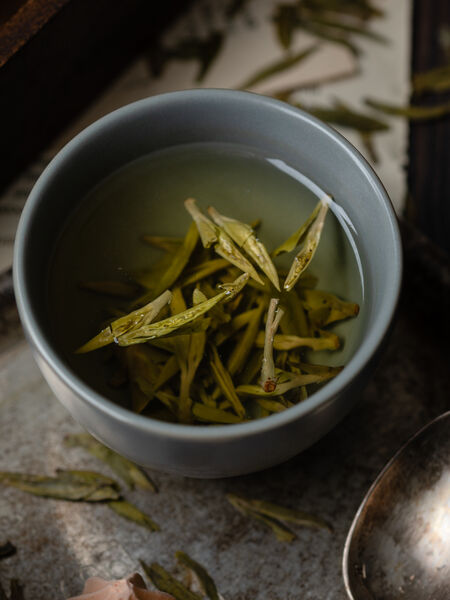 Our Shi Feng Long Jing, which translates to Lion's Peak Dragonwell, is one of the most famous green teas in China. It hails from the equally famous and historic West Lake area in Hangshou, Zhejiang province. This Shi Feng Long Jing is a pre-Qing Ming Festival, and so its early spring harvest results in a tender, young plucking. The liquor is a pale yellow, with a soft, sweet chestnut aroma. The crisp body is delicately nutty, quite complex, with a flickering hint of sweet grass and apricot blossoms.