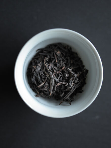 Wuyi Ensemble, known as Da Hong Pao or Wuyi rock tea, is a roasted oolong tea from the Wuyi mountains in Fujian province, China. The high fire treatment gives Wuyi oolong its specific smoky and minerally character. This is a beautifully balanced and complex tea with a deep, yet faint, ripe fruitiness in the background. The flavor is slightly honey-floral and nutty, with hints of white sesame, cinnamon, and sweetened burdock root. There is a lingering sweet caramel aftertaste due to the high fire roasting technique. Wuyi Ensemble oolong is warming and satisfying. Being a good digestive tea it goes well with food or sweets. It is perfect for multiple infusions so you can tease out many layers of intriguing flavor.