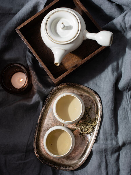 Our ceramic Shizuka tea set is a traditional Japanese yokode kyusu style pot. At first glance, the most striking feature of the kyusu teapot is the ergonomic side handle. This handle allows more control when pouring and is easier on the wrist. Making it a must-have for those who prefer to steep in multiple infusions or gong fu style. Finished with a smooth grey satin glaze the Shizuka teapot is accompanied by four matching teacups.